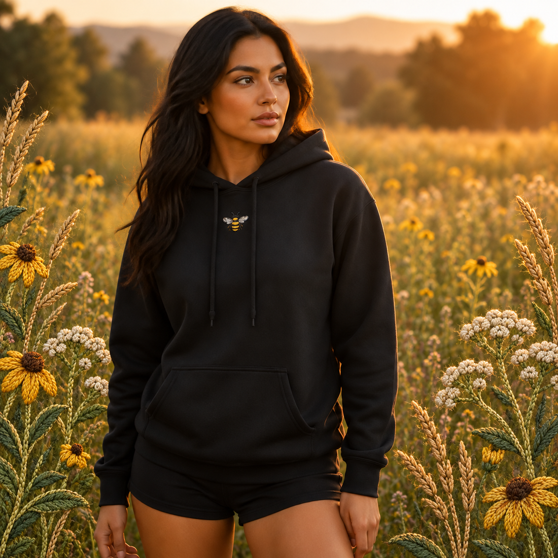 Bee Hoodie – Strength in Community in Black – Bright Future product image — realistic model in an embroidered nature scene.