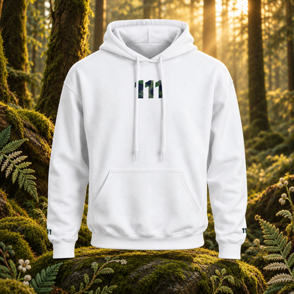 White 111 Forest hoodie with its original chest and cuff design in a sunlit woodland scene with embroidered fern details.