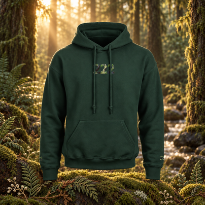 222 - Forest - Balanced Alignment hoodie in a realistic woodland setting with embroidered botanical details.