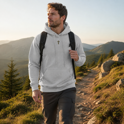 Ash grey Cross hoodie worn hiking on a sunlit mountain trail
